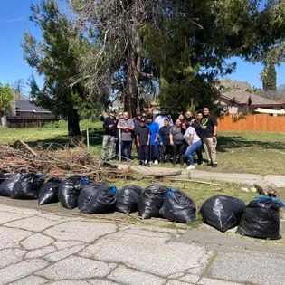 Students doing neighborhood cleanup group effort