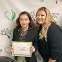 Two people posing with certificate at YRG 2021 graduation Operation New Hope